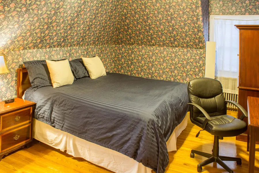 A large appealing room located on the third floor, with a king-size bed